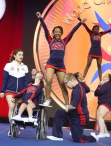 Special Abilities athletes on the USA National Team perform a stunt with an athlete standing on top of one base's thigh and on a wheelchair stand of another athlete along with an ambassador.